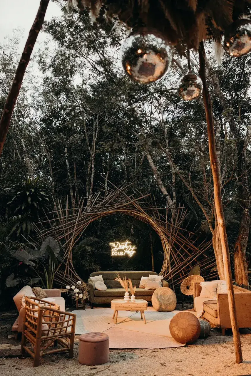 Jungle lounge with rattan seating, dried palm and mirror balls overhead