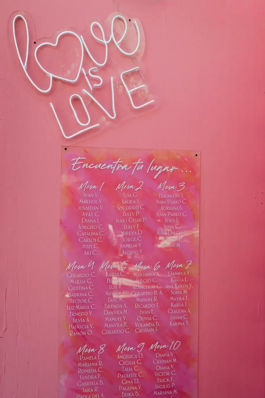Pink neon seating chart wall reading love is love